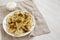 Homemade traditional polish fried potato pierogies on a white plate, low angle view. Copy space