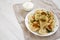 Homemade traditional polish fried potato pierogies on a white plate, low angle view. Copy space