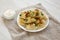 Homemade traditional polish fried potato pierogies on a white plate, side view. Closeup