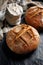 Homemade traditional sourdough loaf of bread on a black background