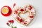 Homemade trendy heart shaped naked cake for Valentines Day, white background, selective focus