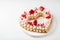 Homemade trendy heart shaped naked cake for Valentines Day, white background, selective focus