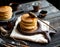 Homemade two stacks of pancakes on wooden boards with pouring honey and honey stick