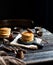 Homemade two stacks of pancakes on wooden boards with pouring honey and honey stick