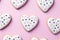Homemade valentine cookies on pastel pink background.