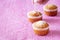 Homemade vanilla muffins with coconut powder. Pink background. Copy space. Selective focus. Good morning concept