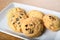 Homemade vanilla, orange, lemon chocolate chip cookies biscuits stack on a white plate