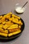 Homemade vegan poelnta chips made with oat milk and cornmeal with vegan aioli sauce to the side