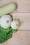 Homemade vegetables. Squash Squash white and lettuce on a wooden background. Green harvest on wooden background. Courgettes on a