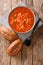 Homemade vegetarian tomato rice soup close up in a bowl. vertical top view