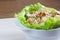 Homemade waldorf salad made of celery, apples and walnuts, served on a bed of fresh leaf lettuce