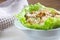 Homemade waldorf salad made of celery, apples and walnuts, served on a bed of fresh leaf lettuce