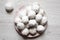 Homemade white mexican wedding cookies on pink plate over white wooden background, view from above. Close-up