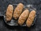 Homemade wholegrain bread rolls for sandwiches, hot dogs on a rustic cutting board, top view