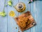 Homemade wholegrain cookies with raisin and nuts, a cup of hot tea and flower on table