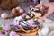 Homemade wicker cupcake with poppy seeds, flowers and icing sugar on a white wooden table. Delicious yeast pastries