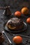 Homemade winter dessert. Traditional British steam chocolate pudding with oranges and clementines on vintage dish with coffee on