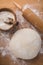 Homemade yeast dough freshly prepared for pizza or bread on wooden background.