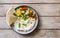 Homemade yogurt cheese labneh with raw vegetable salad and lavash bread served on rustic plate