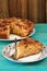 Homemade yummy apple pie with cinnamon and two forks on turquois