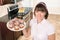 Homemaker holding plate of cupcakes