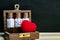 Homeopathy â€“ Close view of homeopathy medicine bottles with cork and heart in wooden old box on wood and dark background.