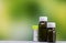 Homeopathy â€“ Close view of homeopathy  medicine bottles on mix green yellow background