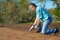 Homeowner patching roof with caulk gun protection from rain storms