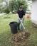 Homeowner Raking Leaves In The Front Yard