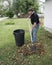 Homeowner Raking Leaves In The Front Yard