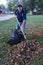 Homeowner Raking Leaves Into A Pile