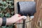 Homeowner about to open the weatherproof cover of a double gang external electrical sockets.