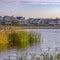 Homes along man made Oquirrh Lake under cloudy sky