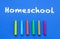 Homeschool. Words or typed text on blue board. Colorful crayons. Top view
