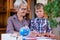 Homeschooling grandmother teaching smart boy, child