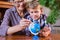 Homeschooling grandmother teaching smart boy, child in geography