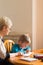 Homeschooling grandmother teaching smart boy, child at home