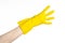 Homework, washing and cleaning of the theme: man\'s hand holding a yellow and wears rubber gloves for cleaning isolated on white ba