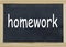 Homework written on a chalkboard