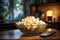 A homey scene popcorn in a glass bowl, TV in action