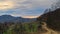 Homolje mountains landscape with a winding gravel country road at sunset of an autumn sunny day