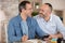 homosexual couple sitting together and counting family budget at home