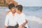 Homosexual portrait young asian couple sitting hug together on beach in summer