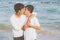 Homosexual portrait young asian couple standing hug and kiss mouth together on beach in summer