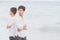 Homosexual portrait young asian couple standing problem on beach in summer