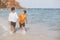 Homosexual portrait young asian couple walking with cheerful together on beach in summer