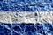 Honduras flag depicted in paint colors on shiny crumpled aluminium foil closeup. Textured banner on rough background