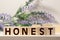 Honest from wooden letters on wooden background
