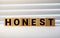 Honest - words from wooden blocks with letters, truthful and sincere honest concept, white background