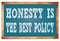 HONESTY IS THE BEST POLICY words on blue wooden frame school blackboard